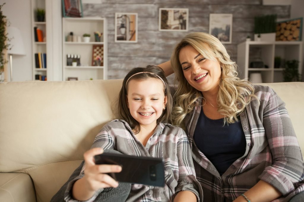 Beautiful mother and her daughter with braces